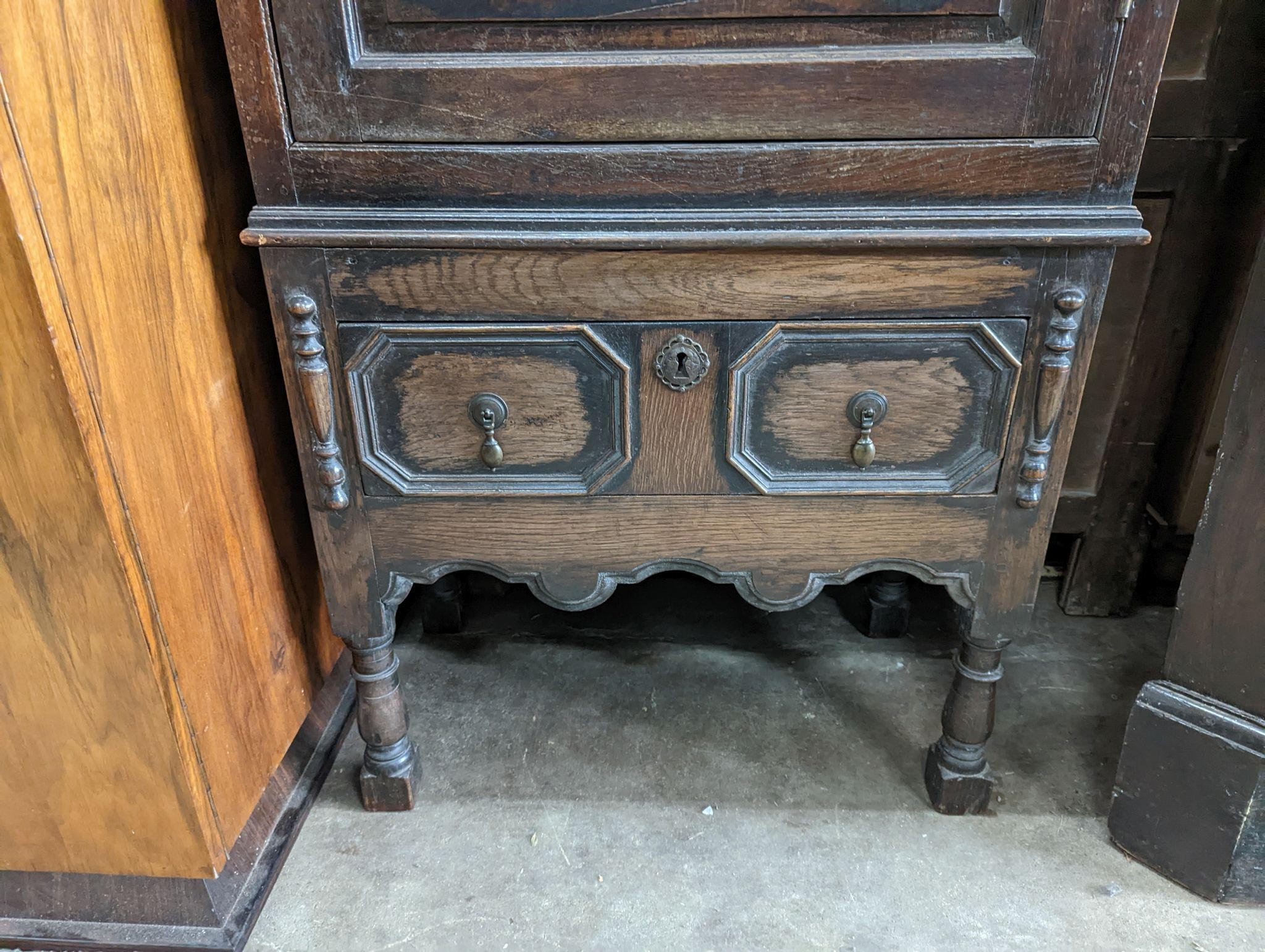 A 17th century style carved panelled oak side cabinet, width 76cm, depth 43cm, height 173cm